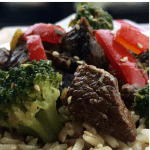 Close up shot of beef and broccoli over rice