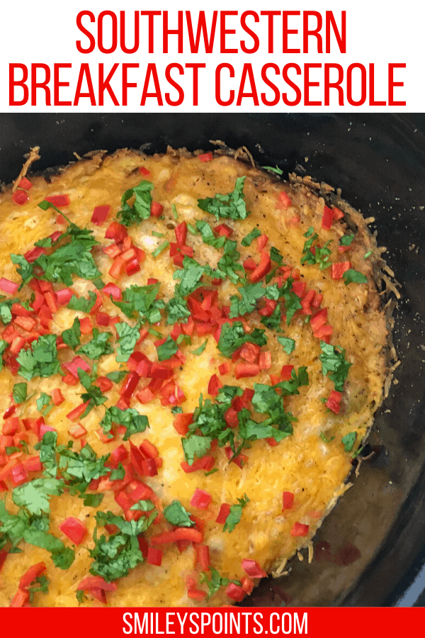 Slow Cooker Southwestern Breakfast Casserole in a slow cooker, topped with diced red peppers and parsley. Top down view.