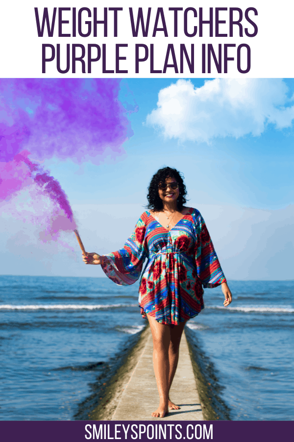 woman holding purple smoke bomb