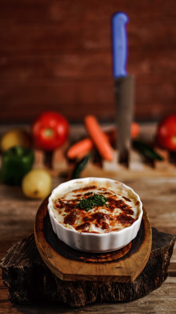 Crockpot lasagna in a white bowl on a round cutting board