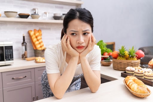 Young Asian woman feeling tired of housework